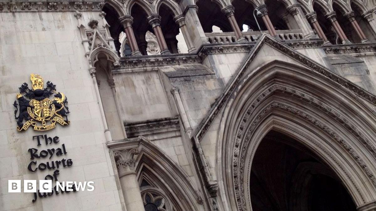 The exterior of the Royal Courts of Justice building, showing its arched entrance and official crest, with a BBC News logo in the corner—highlighting a recent court ruling by a family court judge involving children.