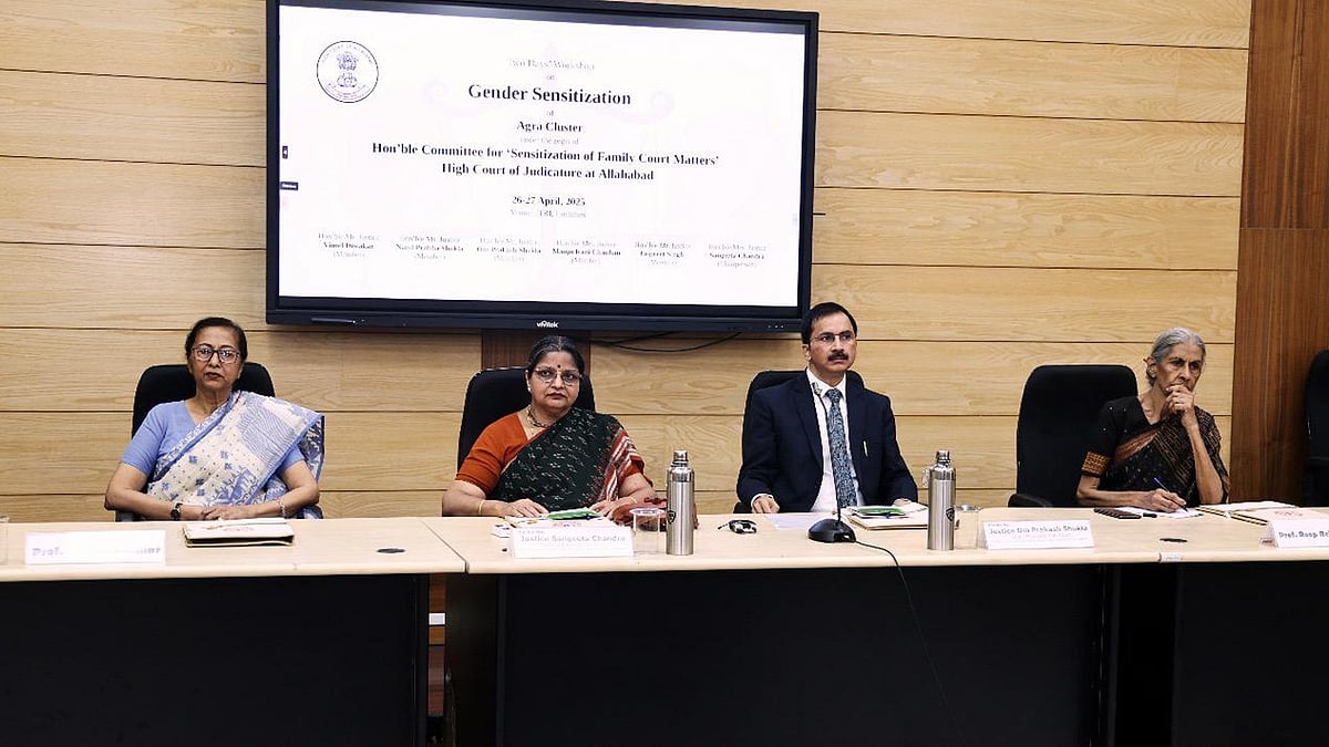 Four panelists, including family court judges, sit at a desk in front of a screen displaying "Gender Sensitization" at an Allahabad High Court event.